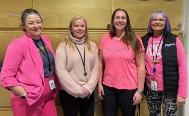 Group of smiling Town staff wearing pink shirts for anti-bullying day