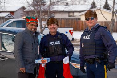 Okotoks Municipal Enforcement and Okotoks RCMP members posing at the Charity Checkstop 