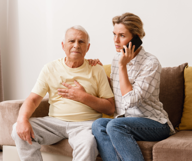 woman calls someone while supporting older male adult 