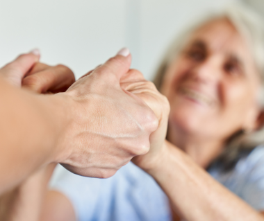supportive hand holding seniors 