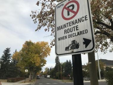 Declared maintenance route sign with no parking symbol on street in Okotoks