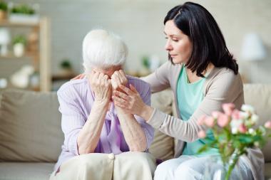woman comforting crying senior